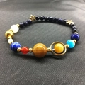Solar system planet bead bracelet with blue goldstone and tiger eye on black background - Solar System Galaxy Style