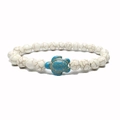 Detailed view of beaded turtle bracelet featuring white turquoise stones and a blue sea turtle - Howlite