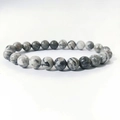 Macro detail of 8mm natural stone beads with unique black and white ink patterns - Map Stone