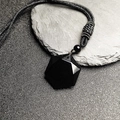 Macro detail of geometric hexagram black obsidian pendant with faceted crystal polish - Black Stone