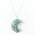 Macro detail of crescent moon pendant with silver wire wrap tree of life on green stone - Green Aventurine