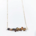 Macro detail of natural irregular tiger eye stones on a minimalist gold link chain necklace - Tiger Eye
