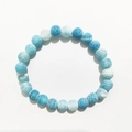 Close-up of 8mm dragon vein agate beads with blue and white cracked textures on elastic cord - 8mm / Lake Blue Weathered Agate
