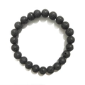 Macro detail of 8mm matte black lava rock beads showing natural porous texture on a bracelet - Lava Stone