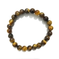 Macro detail of 8mm natural tiger eye stone beads with high polish and chatoyancy - Yellow Tiger Eye