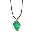Detailed close-up of green crystal arrowhead pendant with golden metal plating on black cord - With Leather Cord / Green