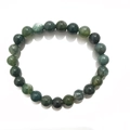 Detail of 8mm natural moss agate beaded bracelet showing green marble texture and round polish - 8mm / Moss Agate