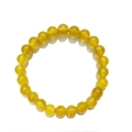 Close-up of 8mm polished yellow agate beads on a single strand stretch bracelet - 8mm / Agate