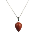 Macro shot of red jasper teardrop pendant with silver chain on white background - Red Jasper