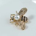 Golden honey bee brooch with white pearls, crystals and black enamel stripes - White KC Gold