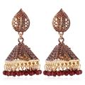 Detail of vintage bohemian Jhumka earrings with ornate bell pendants and red bead drops - Coffee