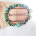 Hand wearing a blue and yellow beaded turtle bracelet with elastic ocean style band - Blue Malachite