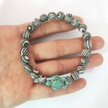 Elastic beaded bracelet with zebra stripe stones and a bright turquoise turtle charm - Black and White Malachite