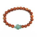 Ethnic stretch bracelet with goldstone beads and a green turquoise turtle charm pendant - Gold Sandstone