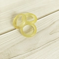 Three translucent yellow agate gemstone rings stacked on a natural wooden background - Lemon Yellow