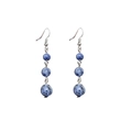 Macro view of blue stone drop earrings with three round beads and silver hooks - Blue Sodalite