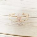 Detail of handmade gold wire-wrapped cuff bracelet featuring a rose quartz hexagonal stone - Rose Quartz