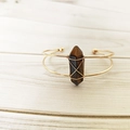 Detail of tiger eye crystal hex pillar wrapped in gold wire on a double-line open bangle - Yellow Tiger Eye