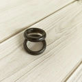 Macro view of two 6mm wide black natural agate gemstone rings on a textured wooden background - Black Stone