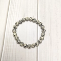 Macro detail of 8mm Dalmatian Jasper beaded bracelet showing natural black spotted texture - Dalmatian Jasper