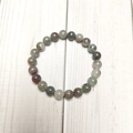 Detailed view of 8mm natural bloodstone beaded stretch bracelet on light wood surface - Bloodstone