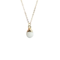 Macro detail of white quartz crystal droplet pendant with golden electroplated edges - White Jade