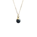Detailed view of faceted teardrop-shaped dark gemstone pendant with golden link chain - Black Stone