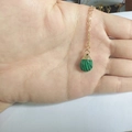 Macro detail of teardrop malachite pendant with elegant gold chain for women - Malachite