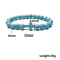 Elastic beaded bracelet with turquoise stones and cross charm displayed on white background - Blue Turquoise