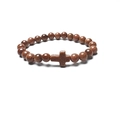 Macro detail of natural goldstone beaded bracelet featuring a central cross charm - Gold Sandstone