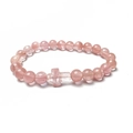 Macro detail of natural rose quartz beads and cross pendant on an elastic bracelet - Watermelon Quartz