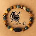 Macro shot of tiger eye stone beads and black cylinder bead with Leo zodiac symbol - Leo