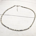 Detail of dalmatian jasper beaded necklace with silver lobster clasp on wood background - Circumference Approx: 38+5cm / White Dot Stone