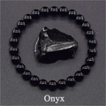 Macro view of polished 8mm black onyx bead bracelet with raw natural stone element - Faux Onyx
