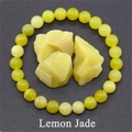 Macro detail of 8mm lemon jade beaded bracelet with raw natural stones on grey surface - Lemon Yellow