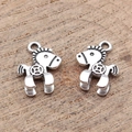 Retro silver horse charms with ancient coin patterns on a rustic wooden background - Antique Silver
