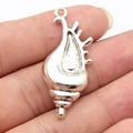 Antique silver conch shell pendant held in hand, vintage style DIY metal charm - Antique Silver