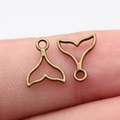 Antique bronze whale tail pendant charms for DIY jewelry held on fingertip - Antique Bronze