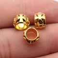 Three gold zinc alloy cross spacer beads with embossed floral patterns for DIY jewelry - Antique Gold