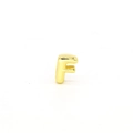 Detailed macro view of a 18K gold plated letter F charm for DIY jewelry bracelets - Letter F Component