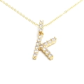 Detailed close-up of golden necklace with crystal-encrusted letter K pendant on white background - Letter K / Gold
