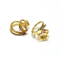 Close-up of golden multi-layer rings with colorful zircon inlays on white background - Spiral Multi-layer / Gold