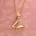 Macro shot of a crystal butterfly pendant with small diamonds on a gold chain necklace - Pure White