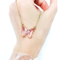 Detail of pink crystal butterfly pendant with sparkling diamonds on a gold necklace - Light Pink