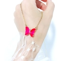 Detail of a pink transparent butterfly pendant necklace with a gold chain and diamond - Plum Red
