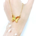 Detail view of a gold butterfly pendant necklace with faceted yellow crystal wings and gems - Yellow