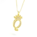 Detailed macro view of the sparkling gold crown initial Q pendant with zircon inlay - Gold - Letter Q