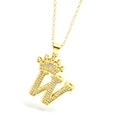 Macro shot of crown and letter W pendant with sparkling zircons on a gold chain - Gold - Letter W