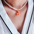 Détail du collier de perles avec un pendentif chien ballon orange brillant - Orange