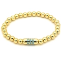 Detail of 18k gold beaded bracelet with a blue capsule bead featuring engraved text - Blue